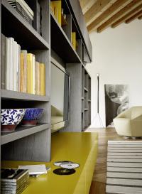 Detail of suspended storage cabinets in matte mustard lacquer (colour not available)