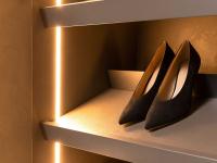 Close-up of the sloped shoe-rack shelf with varnished titanium metal heel-stop