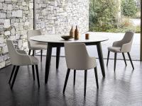 Cardinal shaped table with solid ash legs in the elegant version with ceramic top