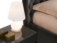 Eternity glass table lamp placed in a bedroom: functional and atmosphere creating lamp