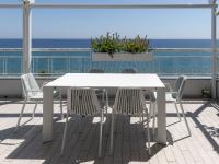 White extendable outdoor table with chairs.
