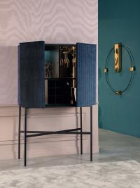 The elegant Extrò bar cabinet, upholstered in velvet with metal structure.