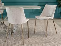 The Agata chair with lacquered metal legs in a matt gold finish 