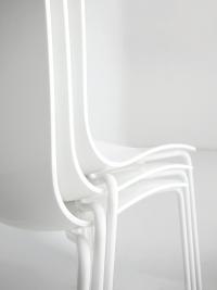 A close up of the stackable chair with metal structure