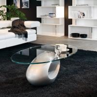 Dubai elliptical coffee table with aluminium lacquered sculptural base and clear glass top, designed for a front sofa position.