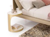 Modì elliptical 'C' shaped coffee table used as a bedside table
