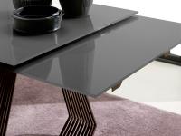 Detail of glossy anthracite lacquered glass top with matching pull-out extensions