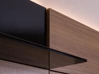 Der Kontrast zwischen dem Schwarz des Rauchglases und der Wärme des Nussbaums Canaletto ist eines der interessantesten Details der Wohnwand Replay 04